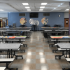12 foot mobile folding cafeteria tables installed in a school lunchroom with rows of commercial bench seating