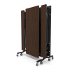 12 foot school folding cafeteria table in Montana walnut laminate finish stored upright on rolling black steel frame for compact commercial storage
