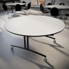 Indoor cafeteria seating featuring 60 inch round PHilip folding lunchroom table with mobile base in commercial dining environment