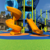Playground with poured in place rubber surfacing showing seamless colorful safety flooring around slides and play structure