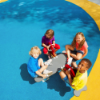 Children playing on poured in place rubber playground surface with soft seamless flooring for safe and inclusive play