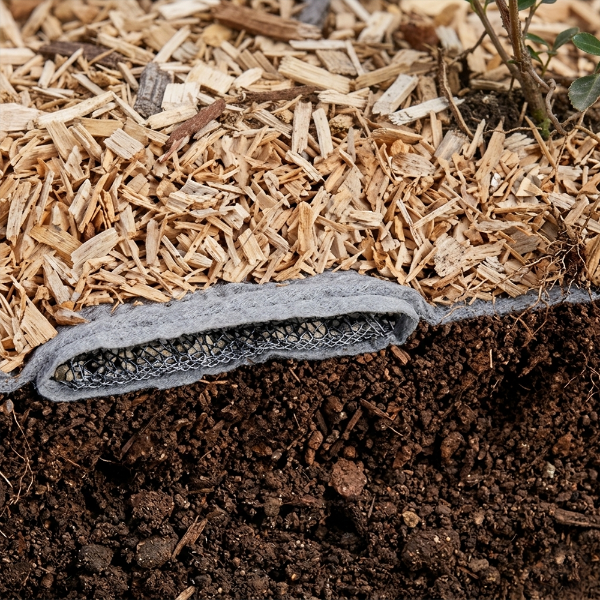 Engineered wood fiber playground surfacing system with drain layer geotextile fabric and sub base for improved drainage