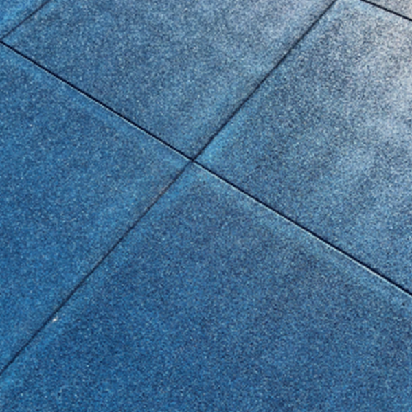 Blue rubber interlocking playground tiles showing textured surface for slip resistance and impact absorbing safety flooring