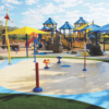 Commercial splash pad playground with colorful rubber surfacing providing safe slip resistant flooring for waterpark environments