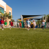 Children playing on SprintPlay Elite artificial turf playground surfacing designed for schools parks and daycare facilities